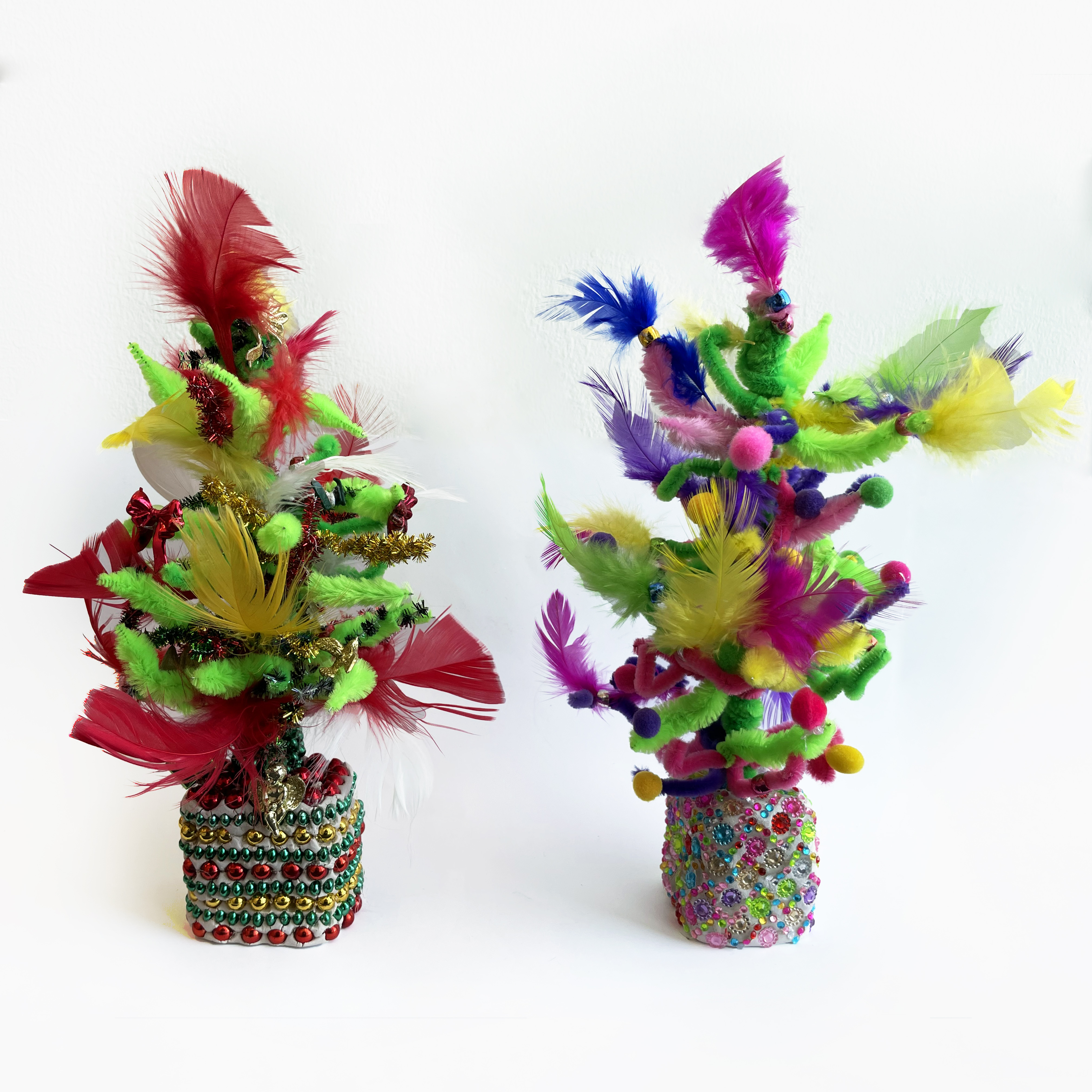 Colorful model trees made with pom poms, feathers, beads, and similar embellishments 