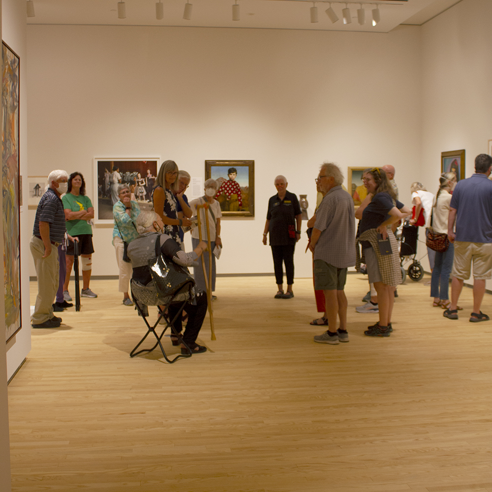 A group of people touring an art museum gallery