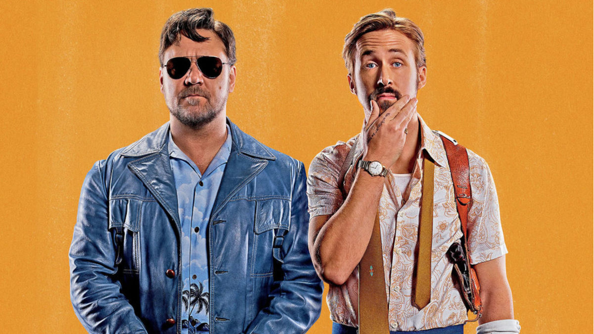 Against a bright orange background, Russell Crowe wears a blue leather jacket and aviators while Ryan Gosling strokes his beard wearing a patterned button-down shirt and an untied tie.