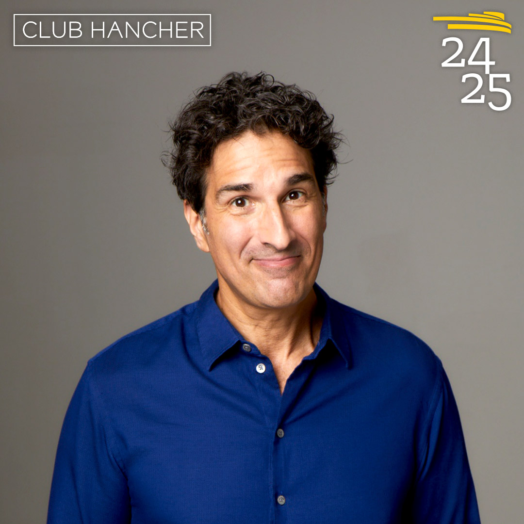 Gary Gulman weaking blue button down close-lipped smiling straight on at the camera. Club Hancher text treatment in upper left corner