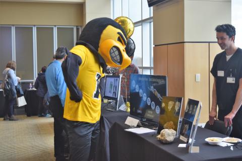 Herky mascot checking an exhibition at the fair