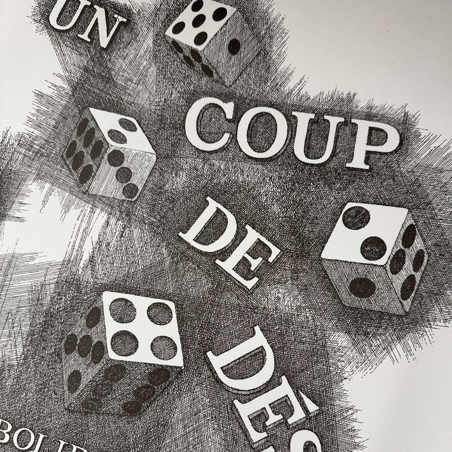 Black and white sketch of four die and the words Un coup de des.