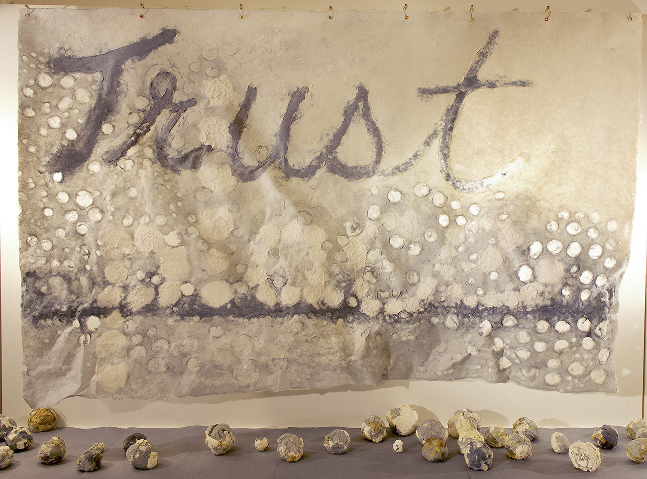 image of paper banner with the words "Trust" and "place" hung on a wall