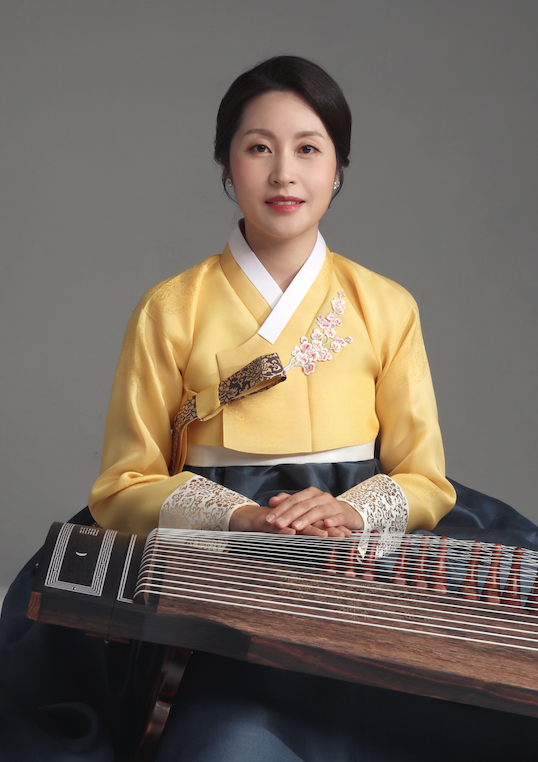 image of soojin lee in traditional Korean clothing and holding a traditional instrument in her lap
