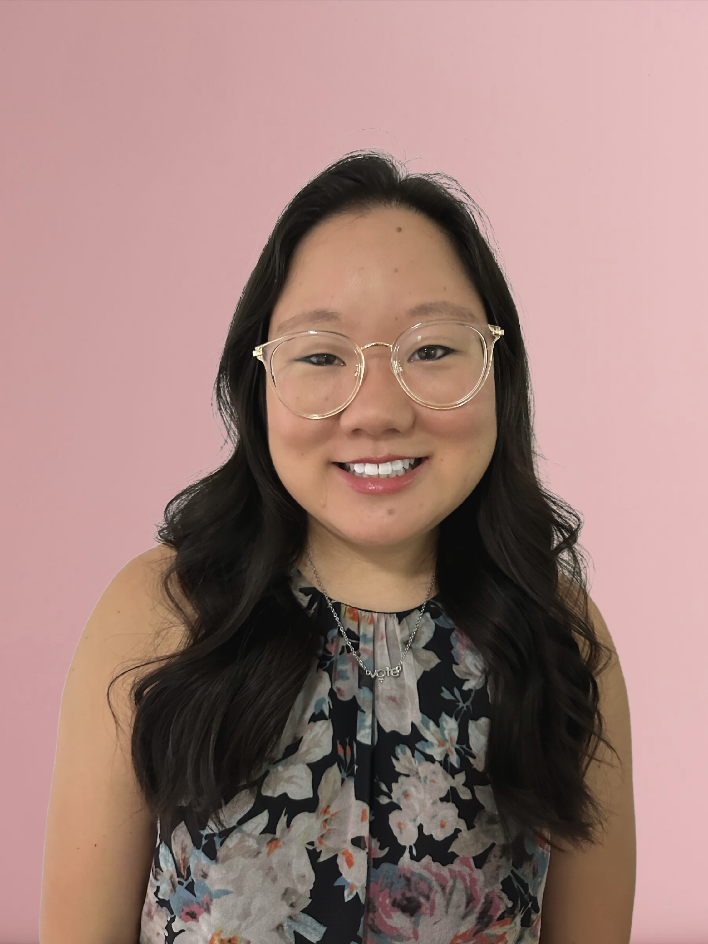 headshot photo of Leah Scharlott with a pink background