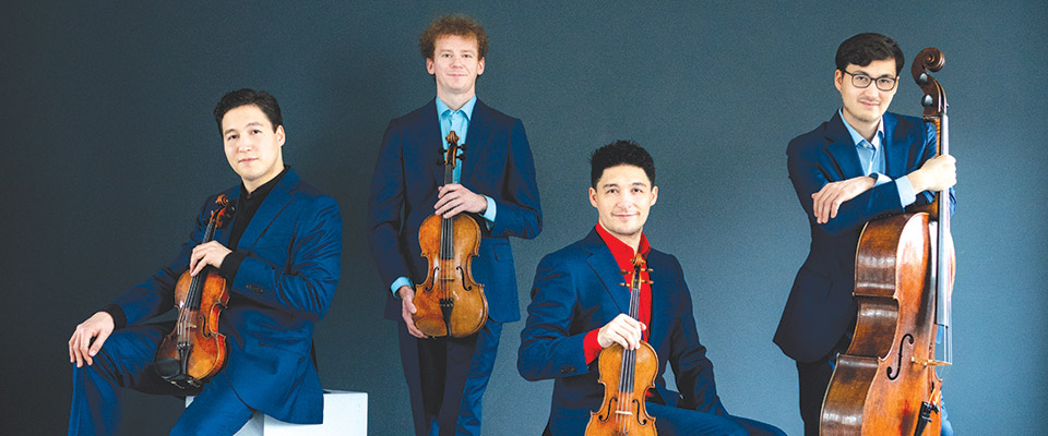 Schumann Quartet members, 4 men dressed in suits and holding their string instruments