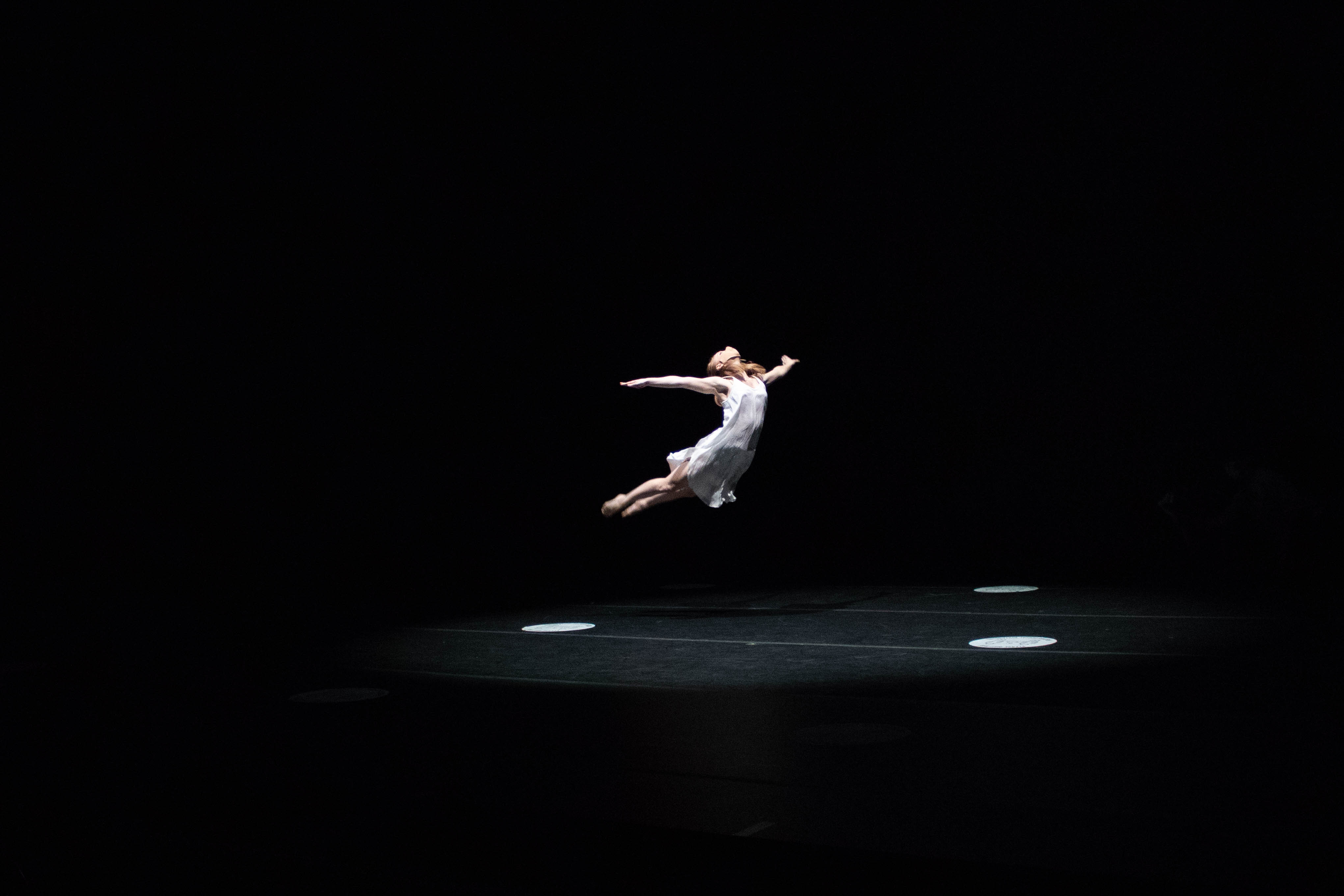 Photo of dancer suspended in the air.