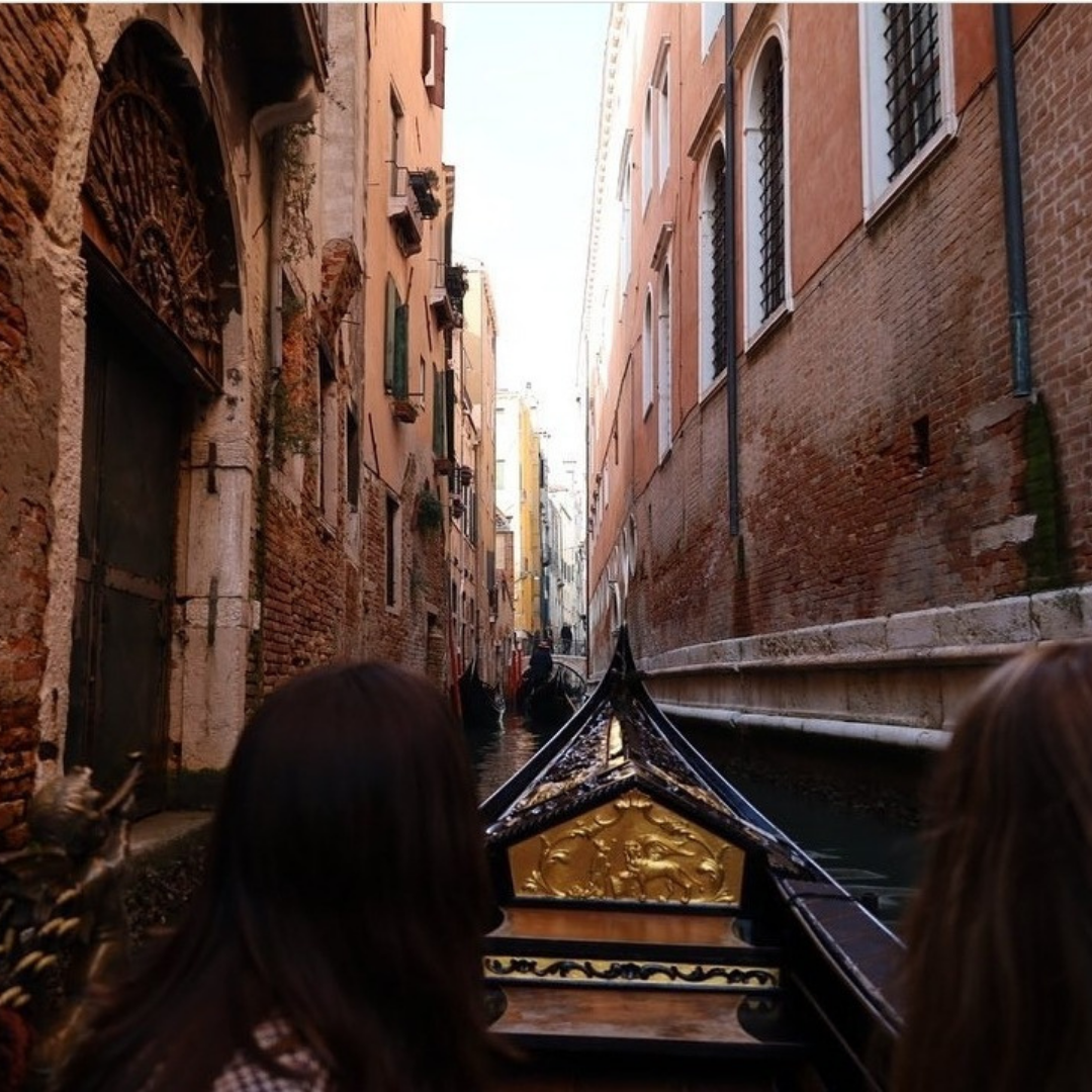 view of a venetian canal from a gondola