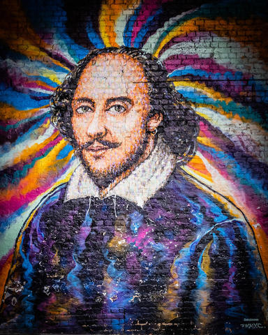 Colorful Shakespeare mural on side of a brick wall
