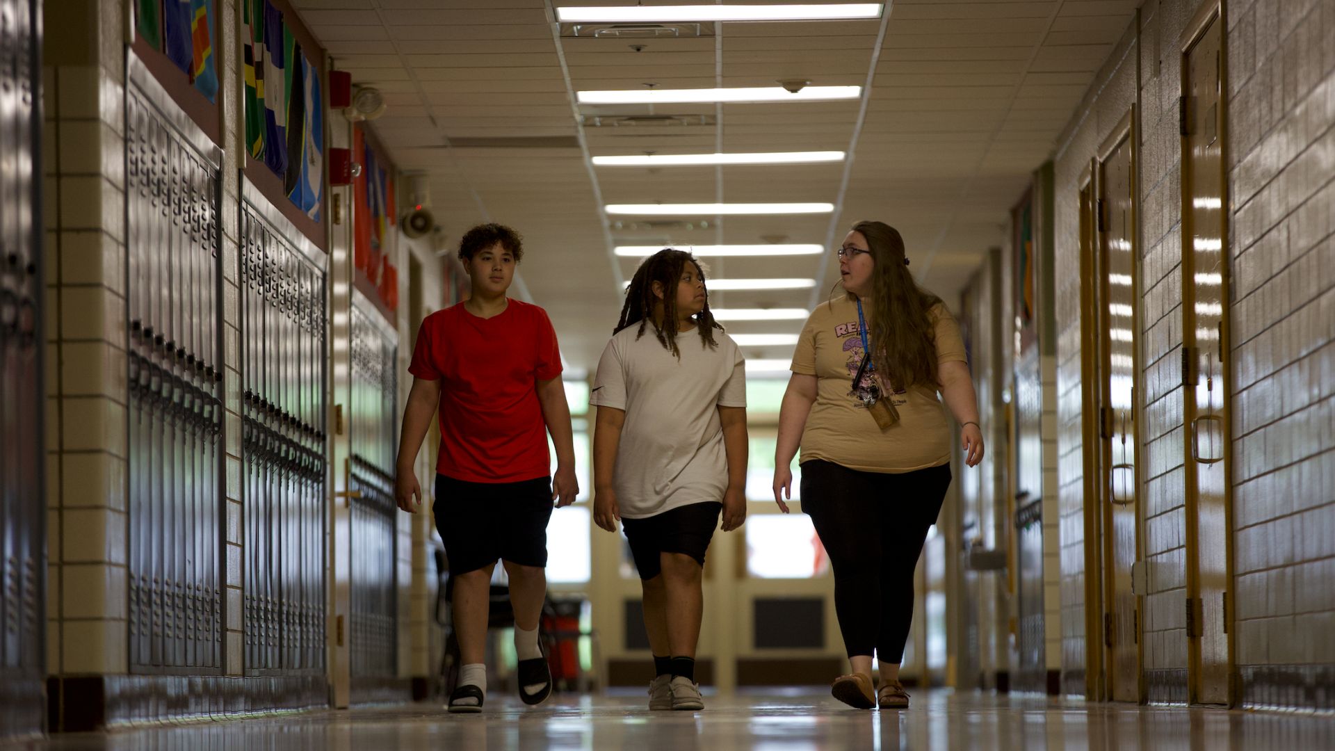 teacher and students walking down hallway