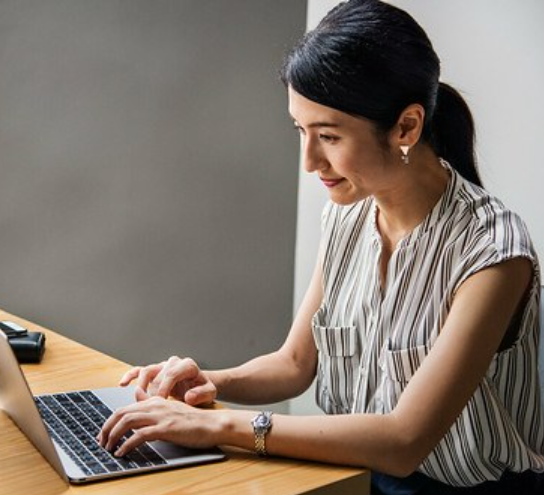 Image of woman working on a laptop